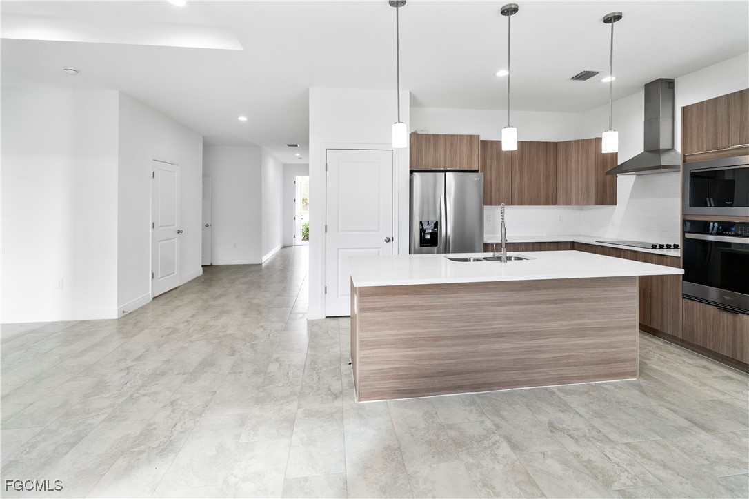 5008 Myrtlewood Road LaBelle, FL 33935 - Photo 7 of 37 a view of kitchen with kitchen island a sink stainless steel appliances and cabinets