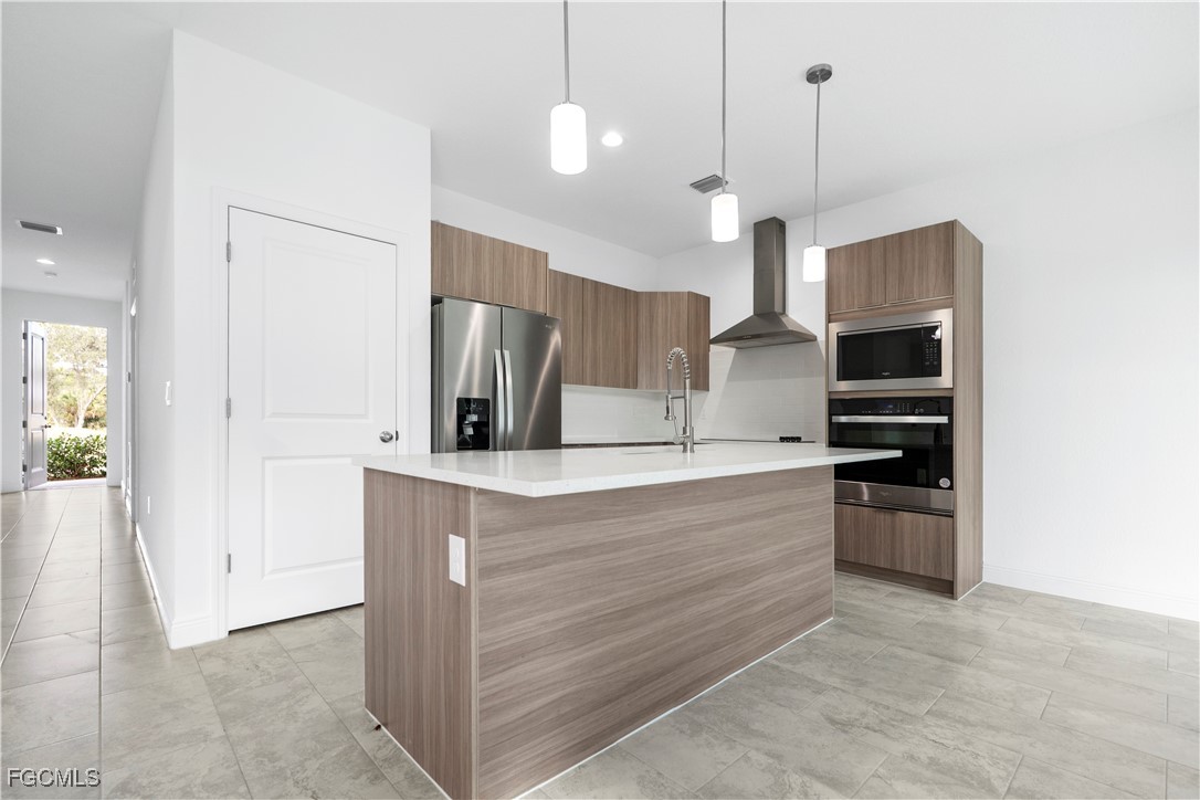 5008 Myrtlewood Road LaBelle, FL 33935 - Photo 8 of 37 a kitchen with stainless steel appliances kitchen island a refrigerator and a sink