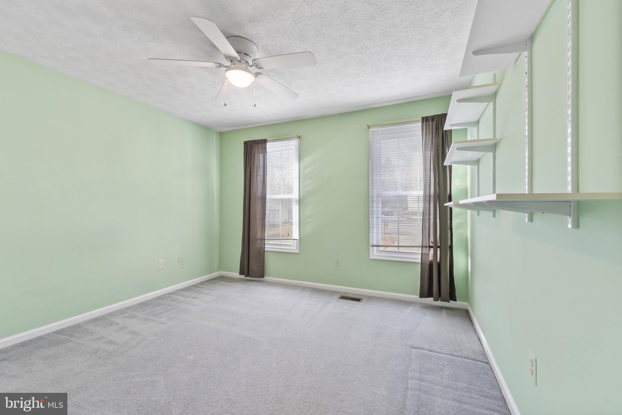 452 Doe Meadow Drive Owings Mills, MD 21117 - Photo 14 of 34 an empty room with windows and fan