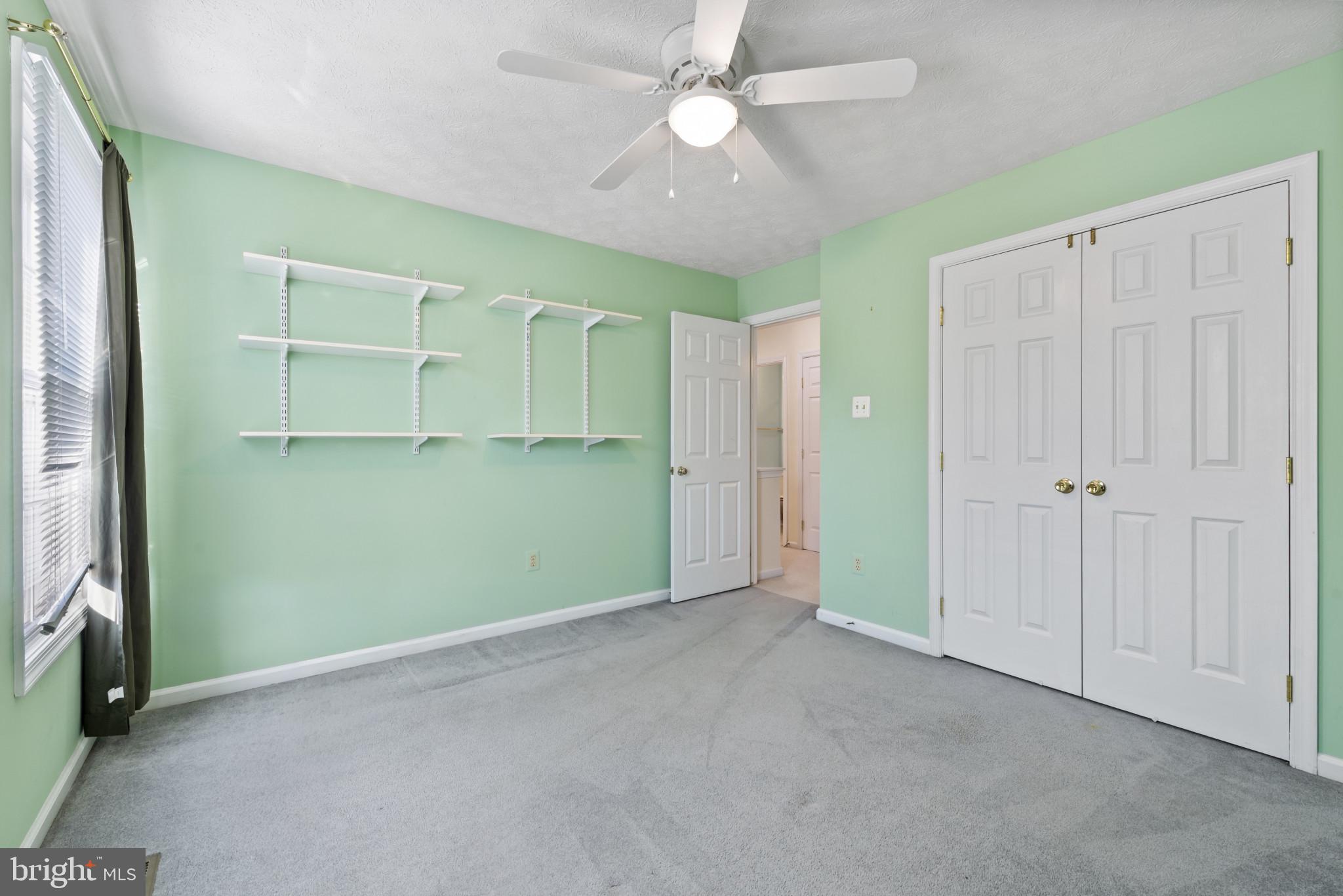 452 Doe Meadow Drive Owings Mills, MD 21117 - Photo 15 of 34 an empty room with closet and fan