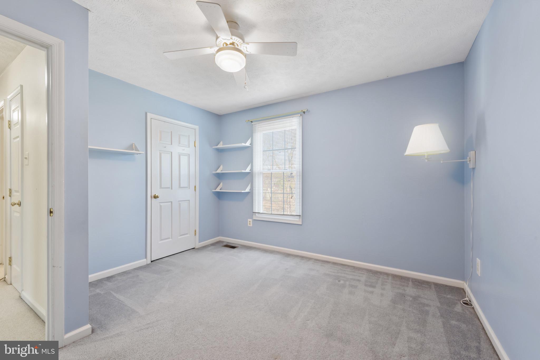 452 Doe Meadow Drive Owings Mills, MD 21117 - Photo 16 of 34 an empty room with a ceiling fan and a window