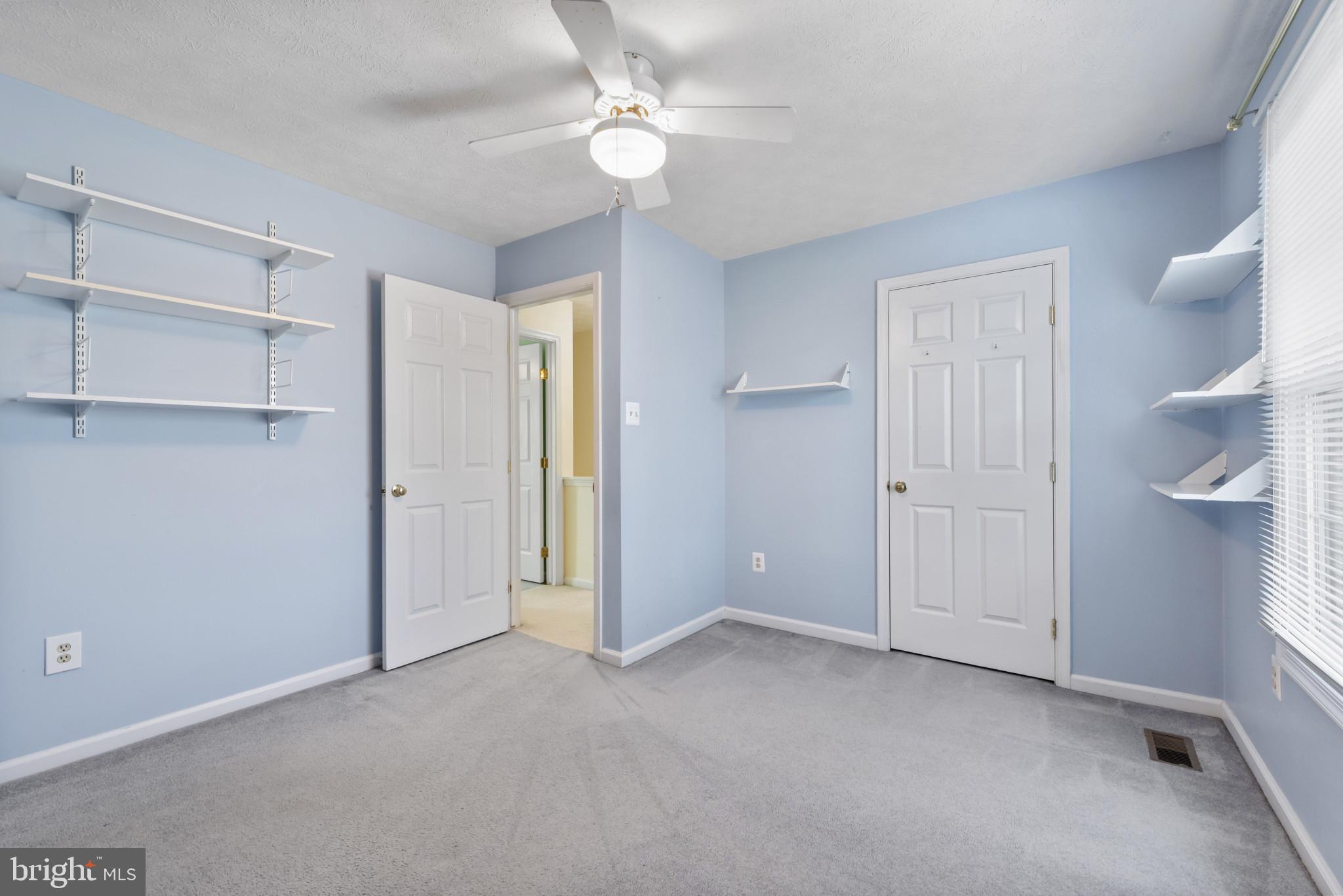 452 Doe Meadow Drive Owings Mills, MD 21117 - Photo 17 of 34 a view of an empty room and a ceiling fan
