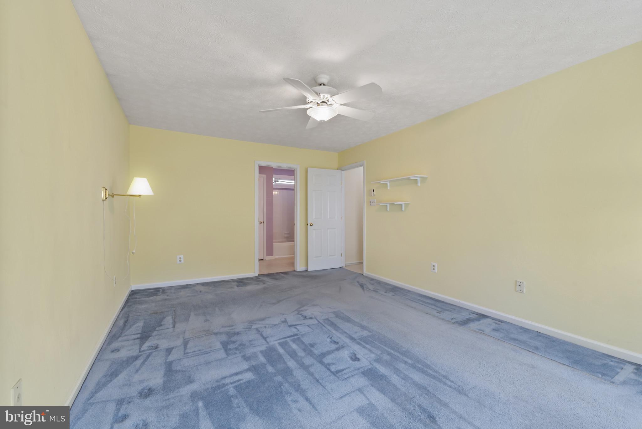 452 Doe Meadow Drive Owings Mills, MD 21117 - Photo 22 of 34 an empty room with a ceiling fan and a window