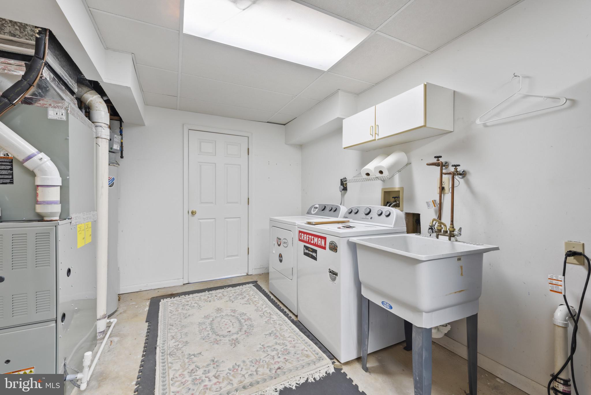 452 Doe Meadow Drive Owings Mills, MD 21117 - Photo 27 of 34 a utility room with cabinets washer and dryer