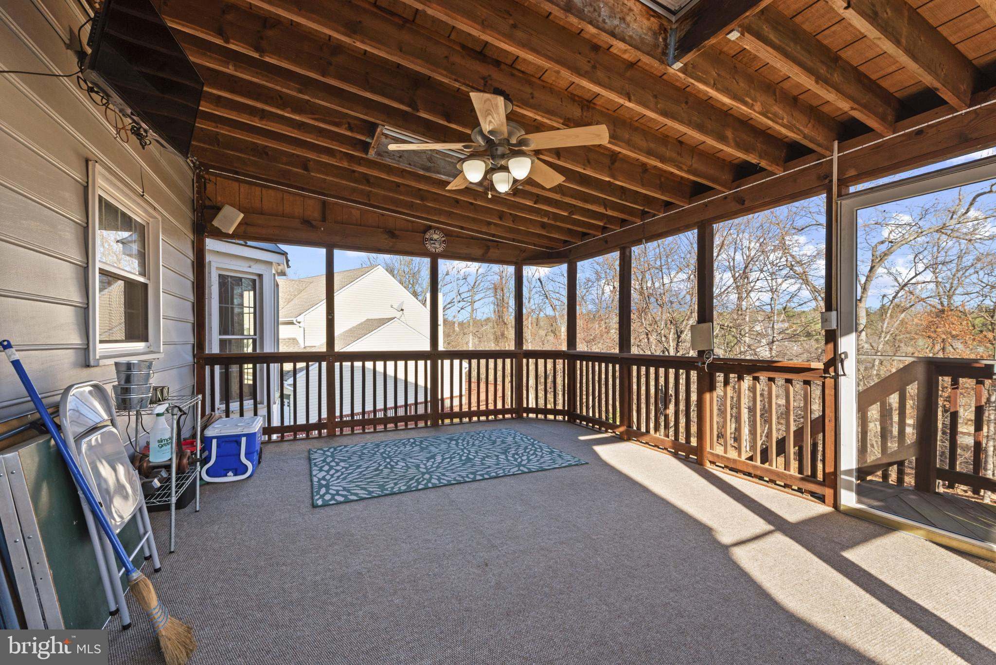 452 Doe Meadow Drive Owings Mills, MD 21117 - Photo 28 of 34 a view of a porch with wooden floor and roof with stairs