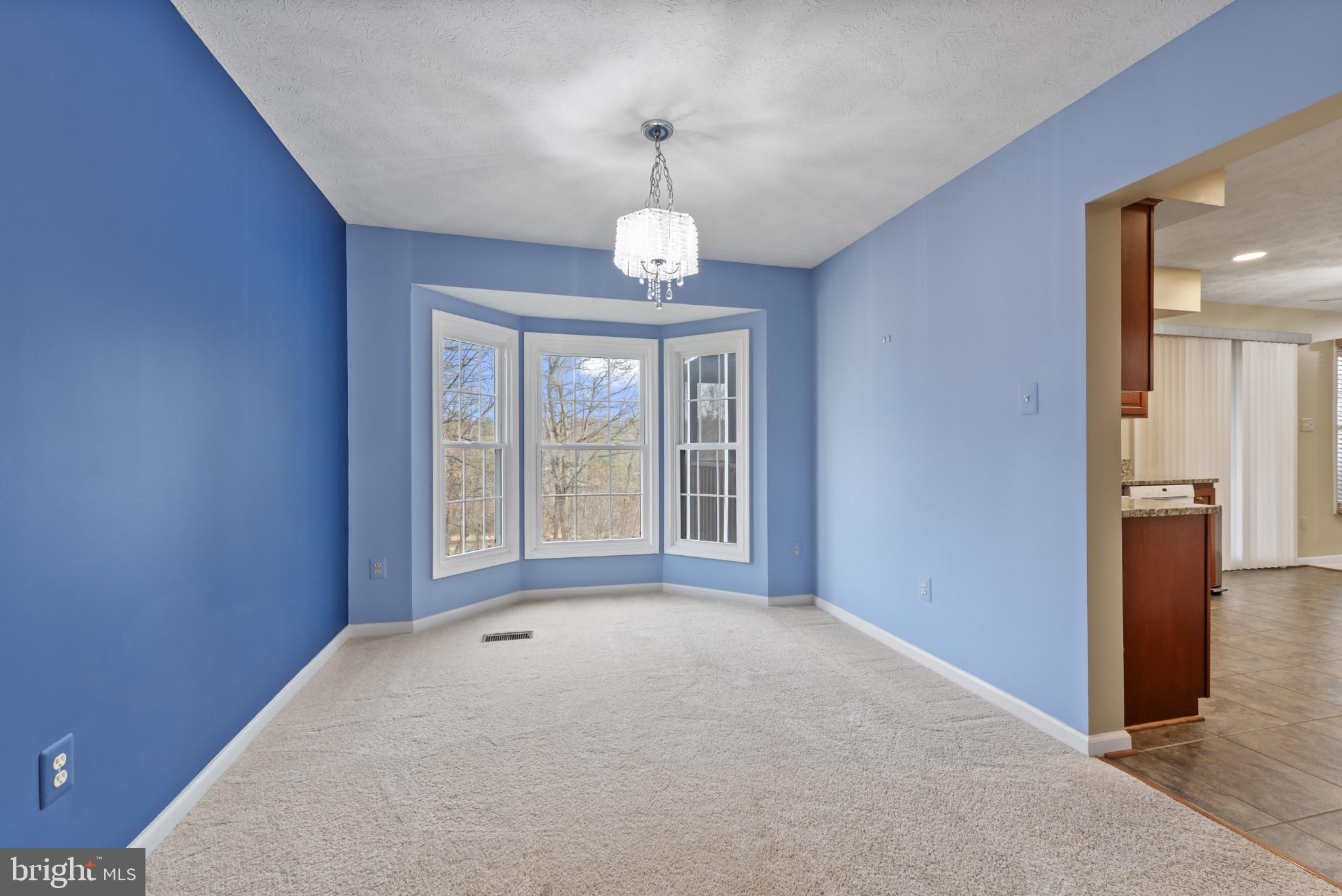 452 Doe Meadow Drive Owings Mills, MD 21117 - Photo 10 of 34 wooden floor and a chandelier in a room