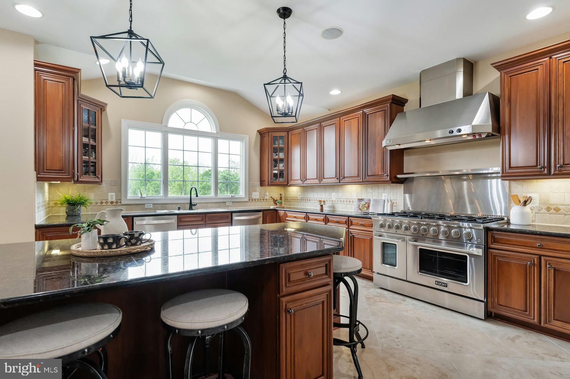 18102 Eaglesham Court Leesburg, VA 20175 - Photo 17 of 92 a kitchen with stainless steel appliances granite countertop a stove a sink dishwasher a dining table and chairs with wooden floor