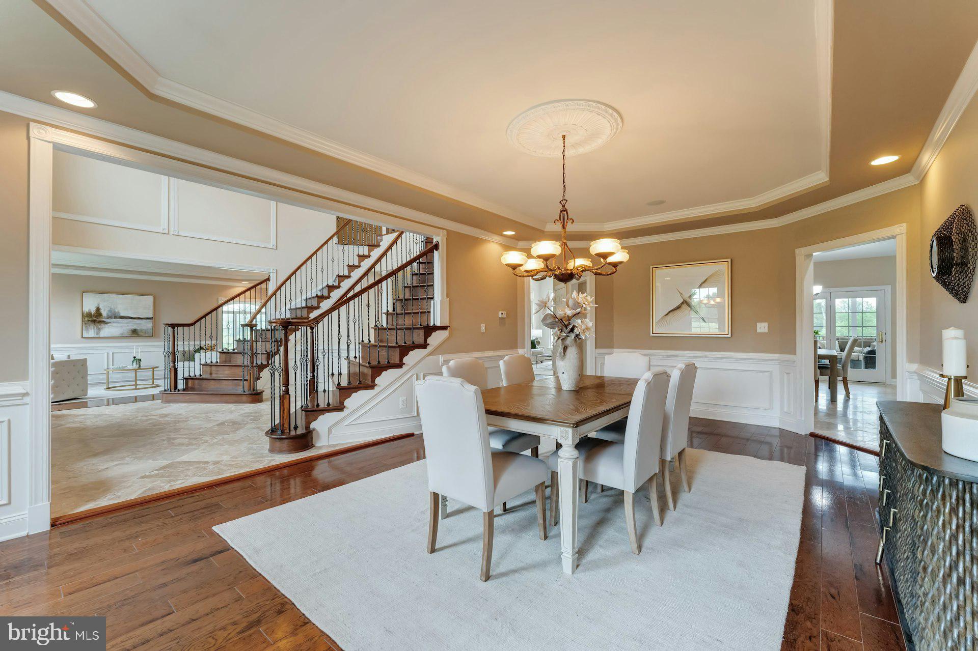 18102 Eaglesham Court Leesburg, VA 20175 - Photo 20 of 92 a view of a dining room with furniture a chandelier and wooden floor