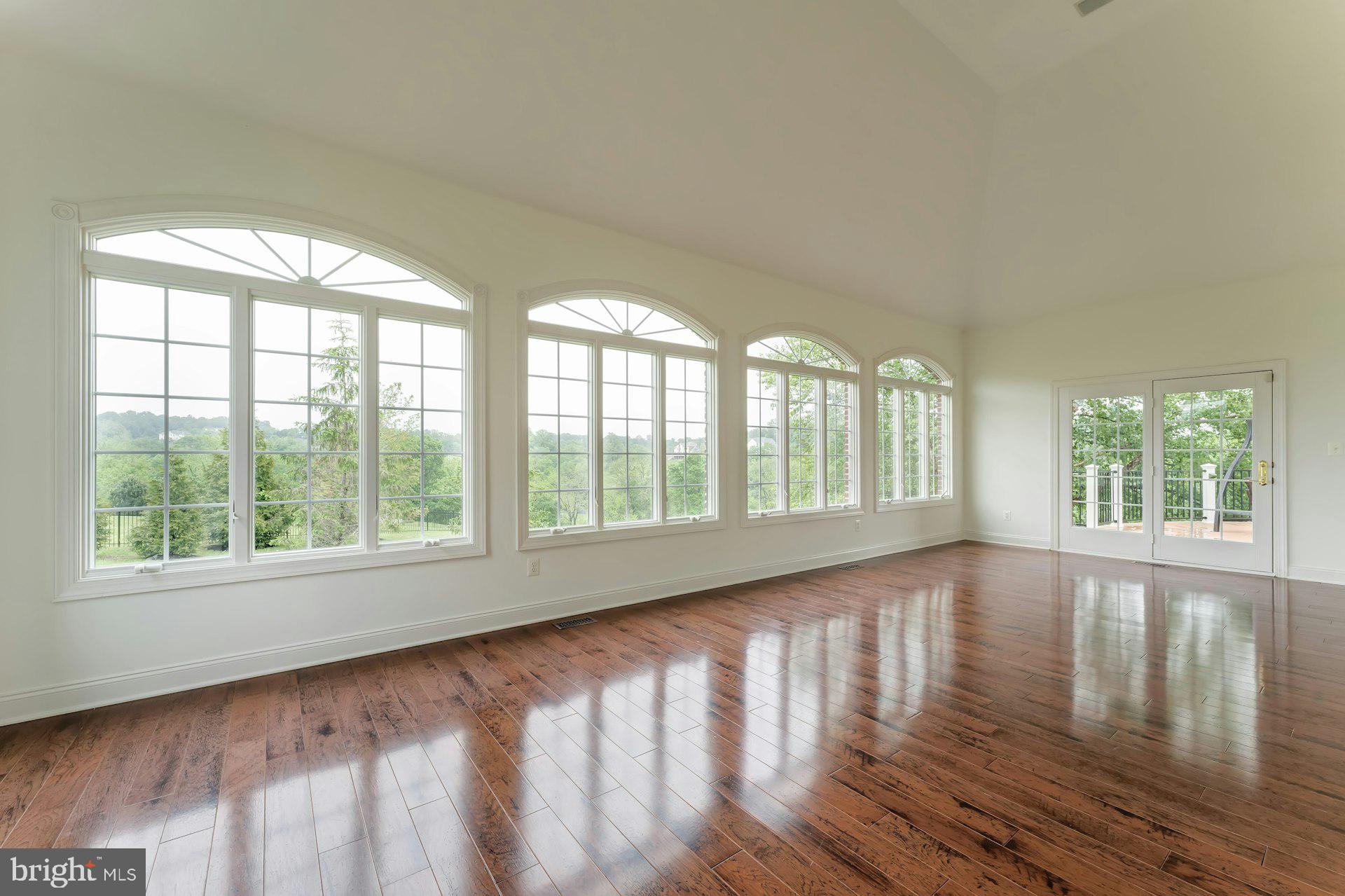 18102 Eaglesham Court Leesburg, VA 20175 - Photo 26 of 92 a view of an empty room with wooden floor and a window