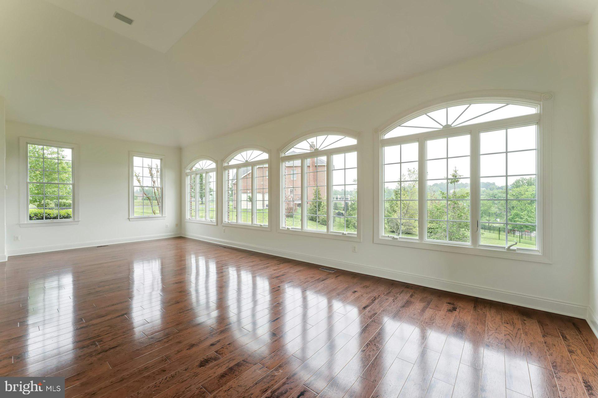 18102 Eaglesham Court Leesburg, VA 20175 - Photo 27 of 92 a view of an empty room with wooden floor and a window