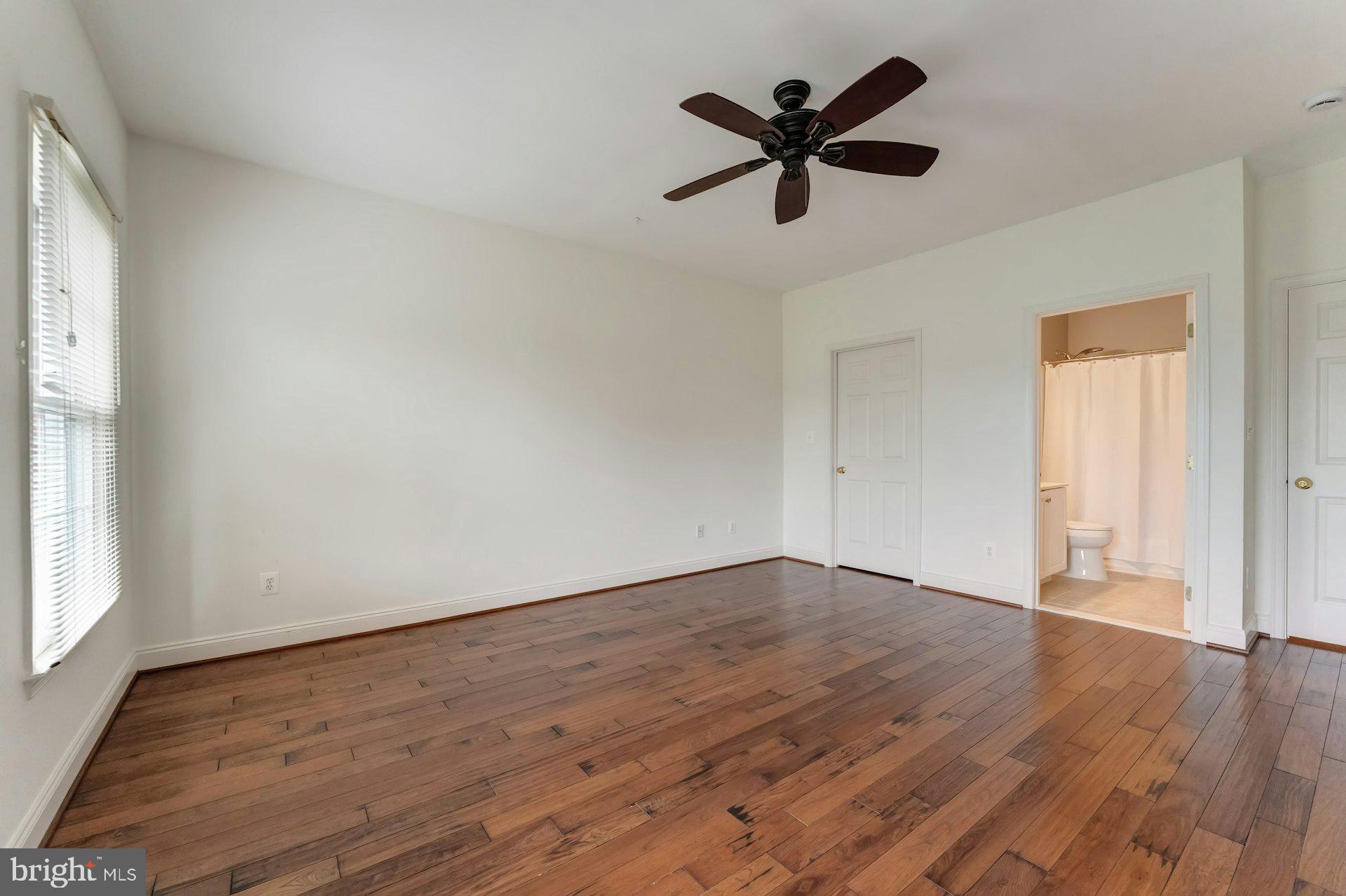18102 Eaglesham Court Leesburg, VA 20175 - Photo 50 of 92 an empty room with wooden floor and windows