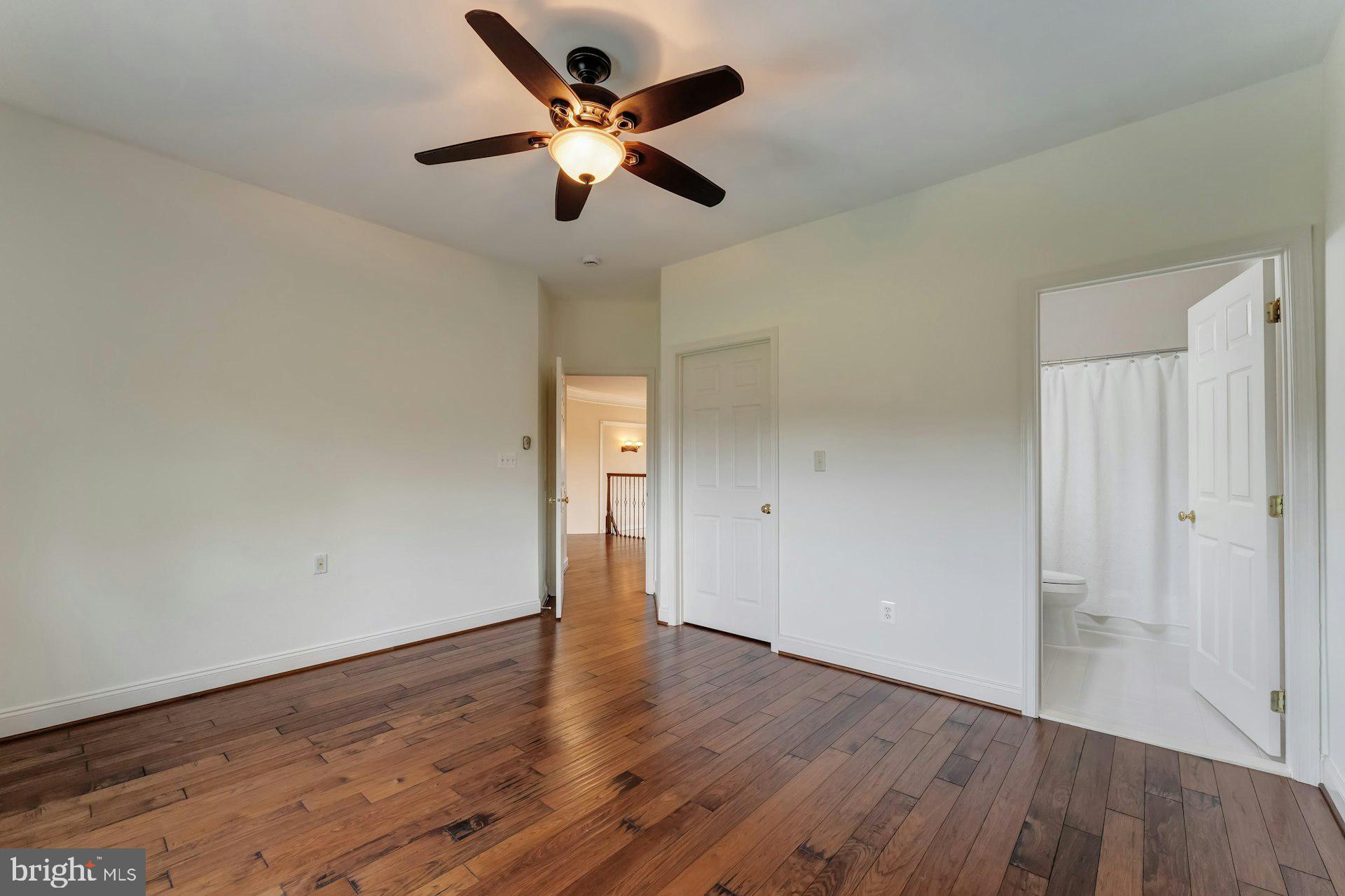 18102 Eaglesham Court Leesburg, VA 20175 - Photo 54 of 92 an empty room with wooden floor and a ceiling fan