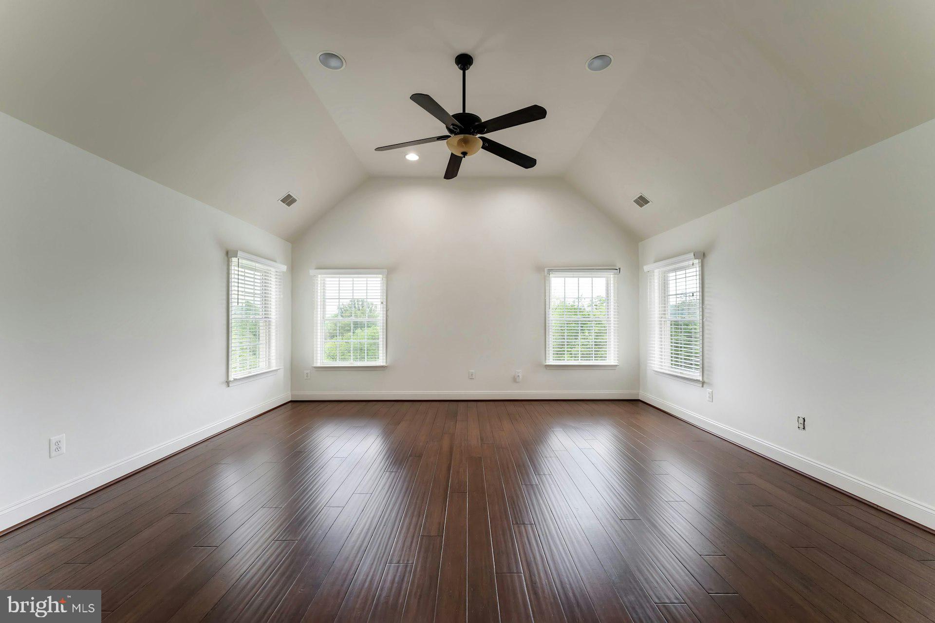 18102 Eaglesham Court Leesburg, VA 20175 - Photo 57 of 92 a view of an empty room with wooden floor and a window