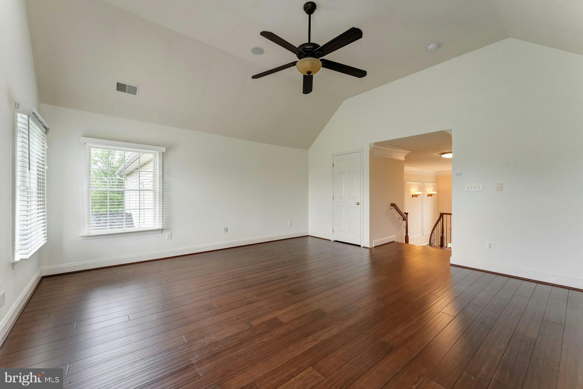18102 Eaglesham Court Leesburg, VA 20175 - Photo 58 of 92 an empty room with wooden floor fan and windows
