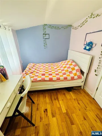 a bed sitting in a bedroom next to a window