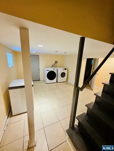a view of a hallway with wooden cabinets and dryer
