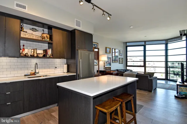 a kitchen with a table chairs refrigerator and sink