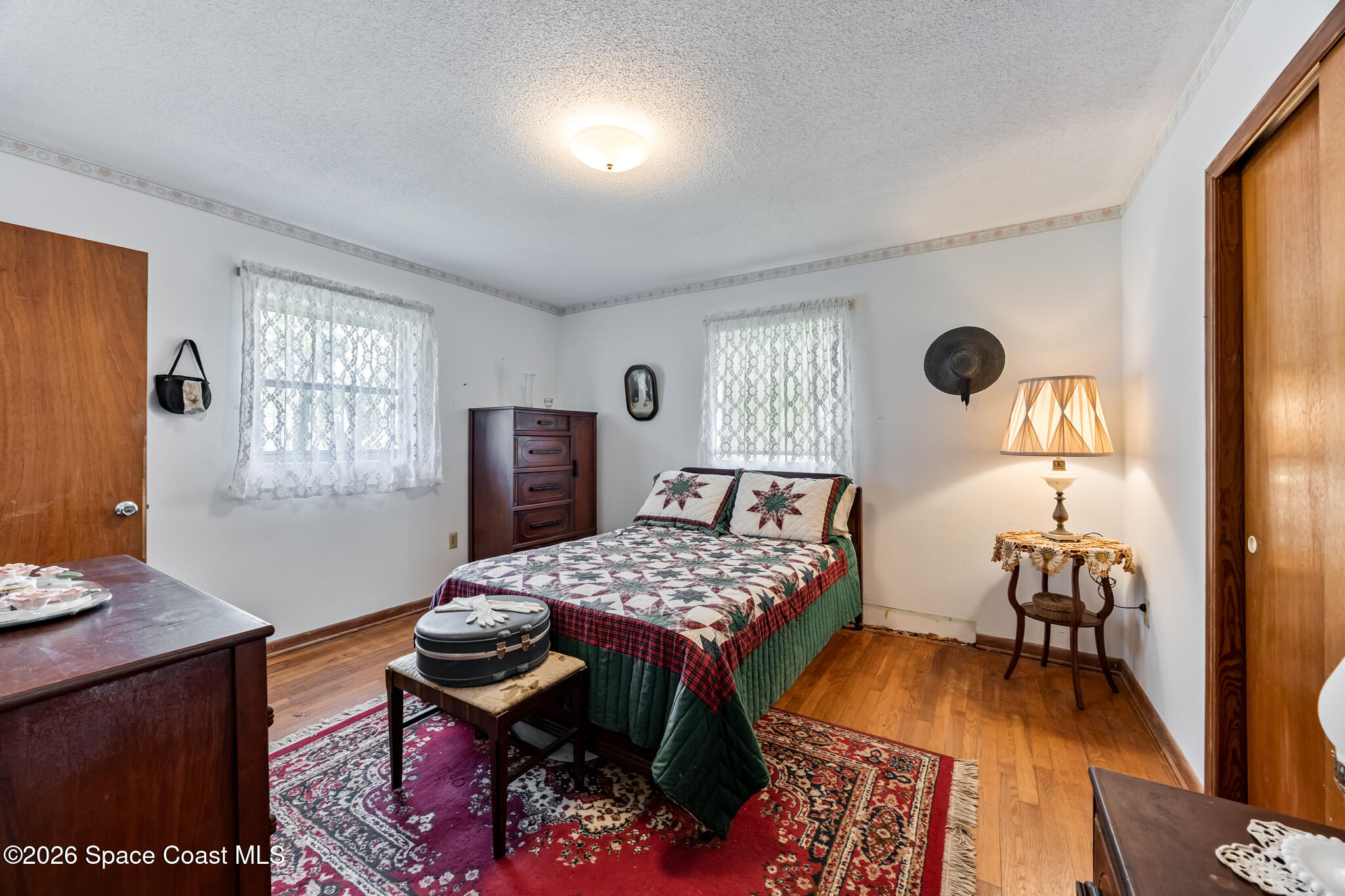 2030 City Acres Road Melbourne, FL 32904 - Photo 12 of 31 a bedroom with a bed and wooden floor
