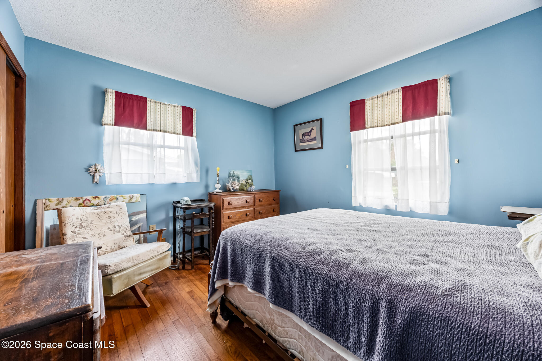 2030 City Acres Road Melbourne, FL 32904 - Photo 14 of 31 a bedroom with a bed and wooden floor