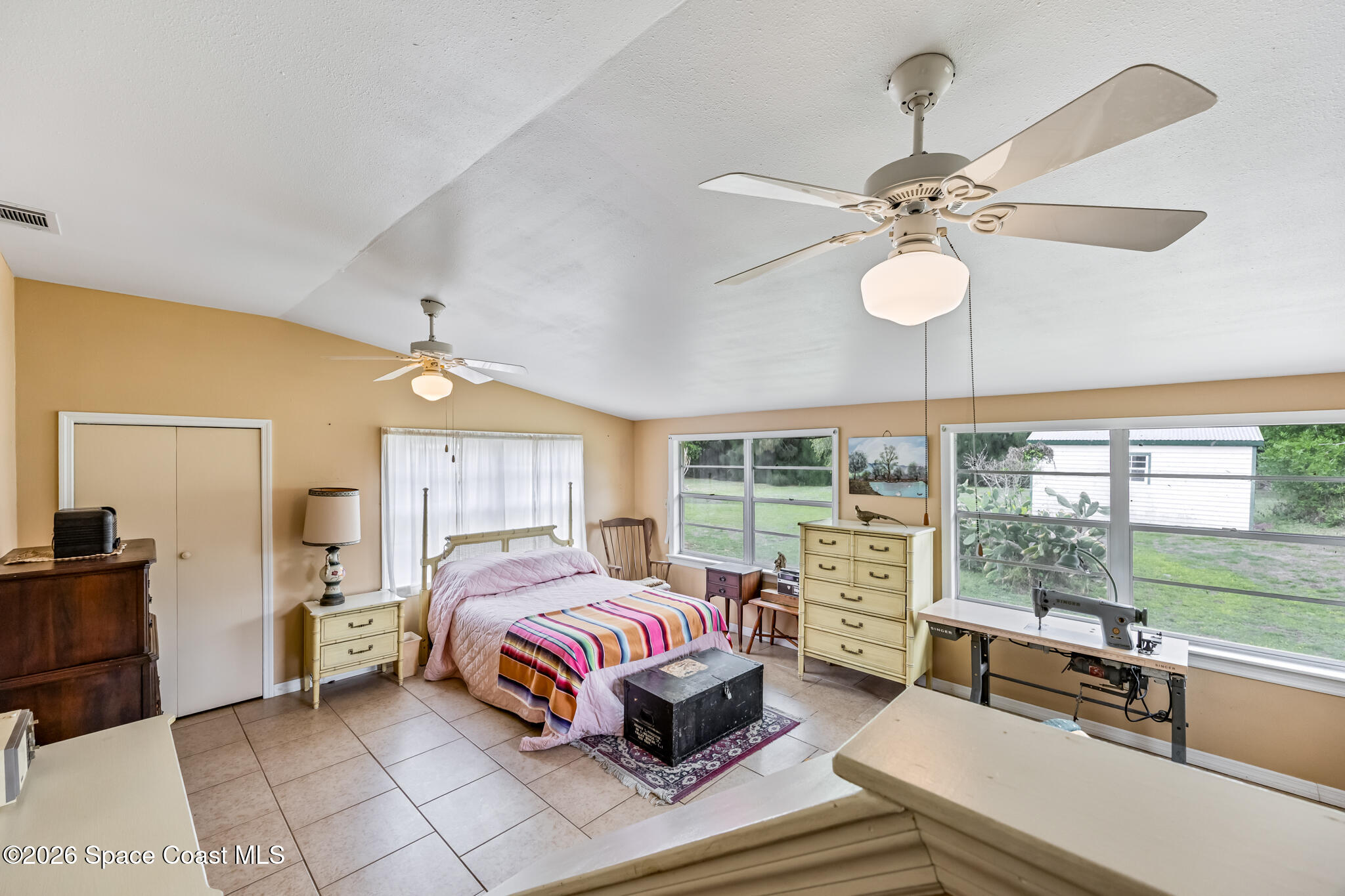 2030 City Acres Road Melbourne, FL 32904 - Photo 16 of 31 a bedroom with a bed couch and window