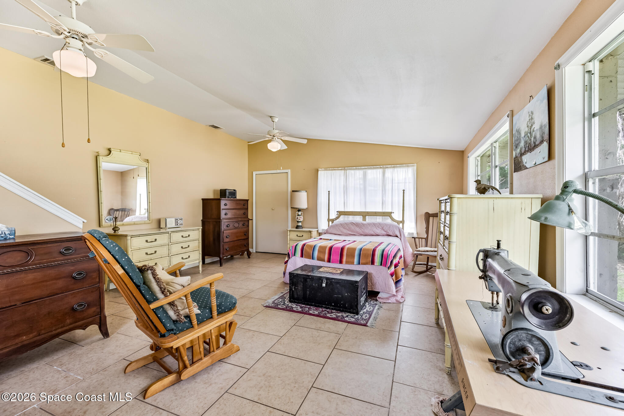 2030 City Acres Road Melbourne, FL 32904 - Photo 17 of 31 a living room with furniture a flat screen tv and a window