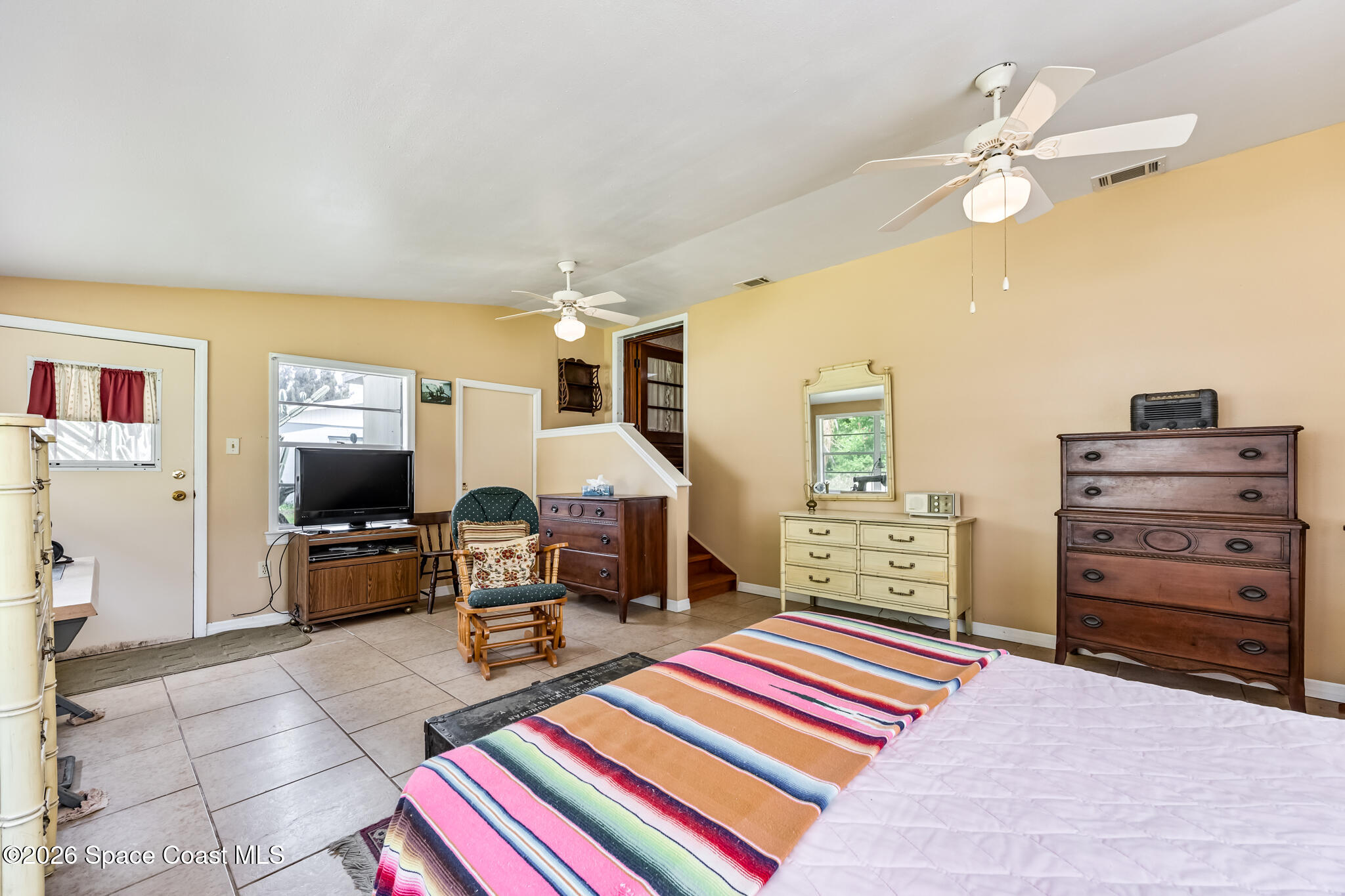 2030 City Acres Road Melbourne, FL 32904 - Photo 19 of 31 a bedroom with furniture and a flat screen tv