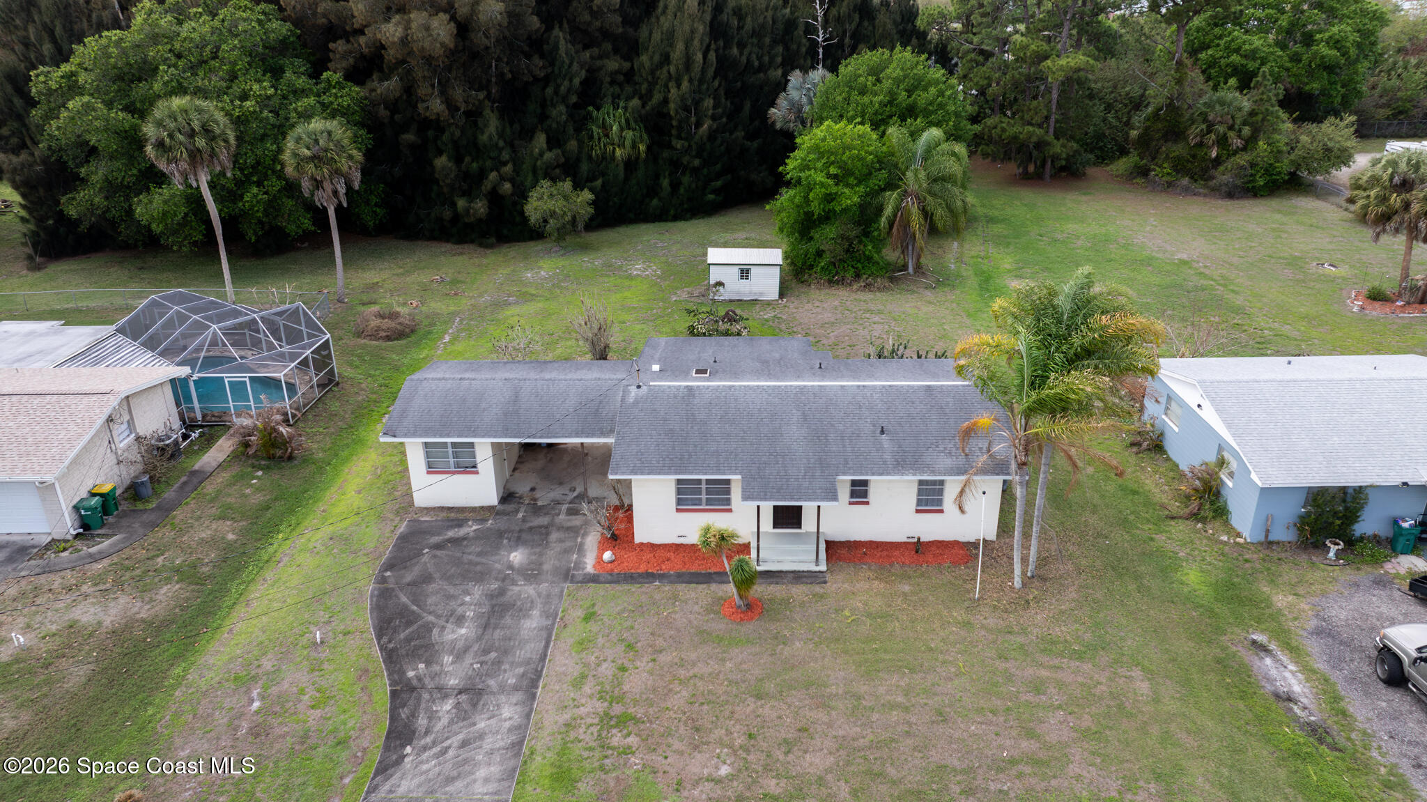 2030 City Acres Road Melbourne, FL 32904 - Photo 23 of 31 an aerial view of a house with swimming pool and a yard