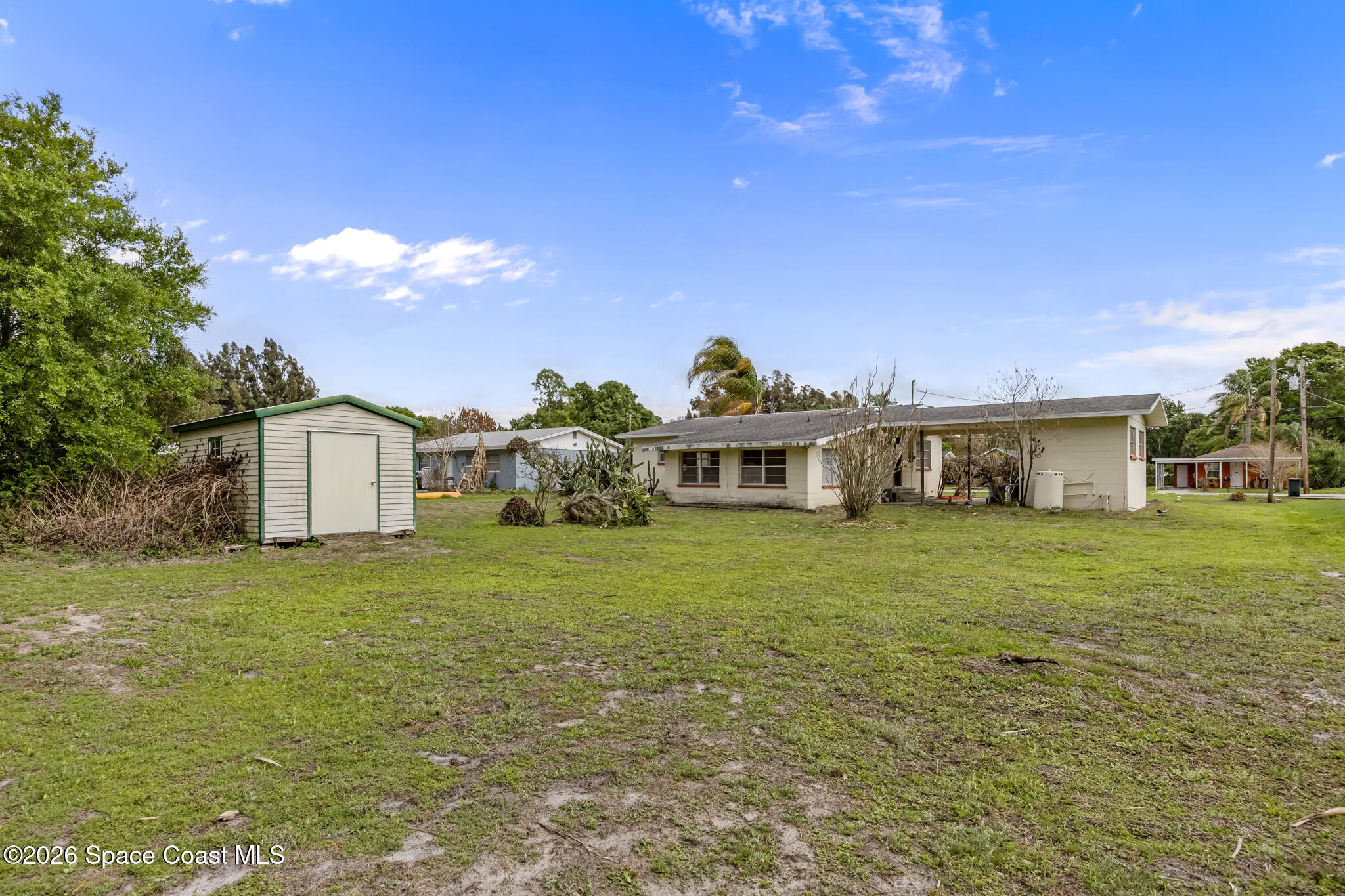 2030 City Acres Road Melbourne, FL 32904 - Photo 25 of 31 a front view of a house with a garden