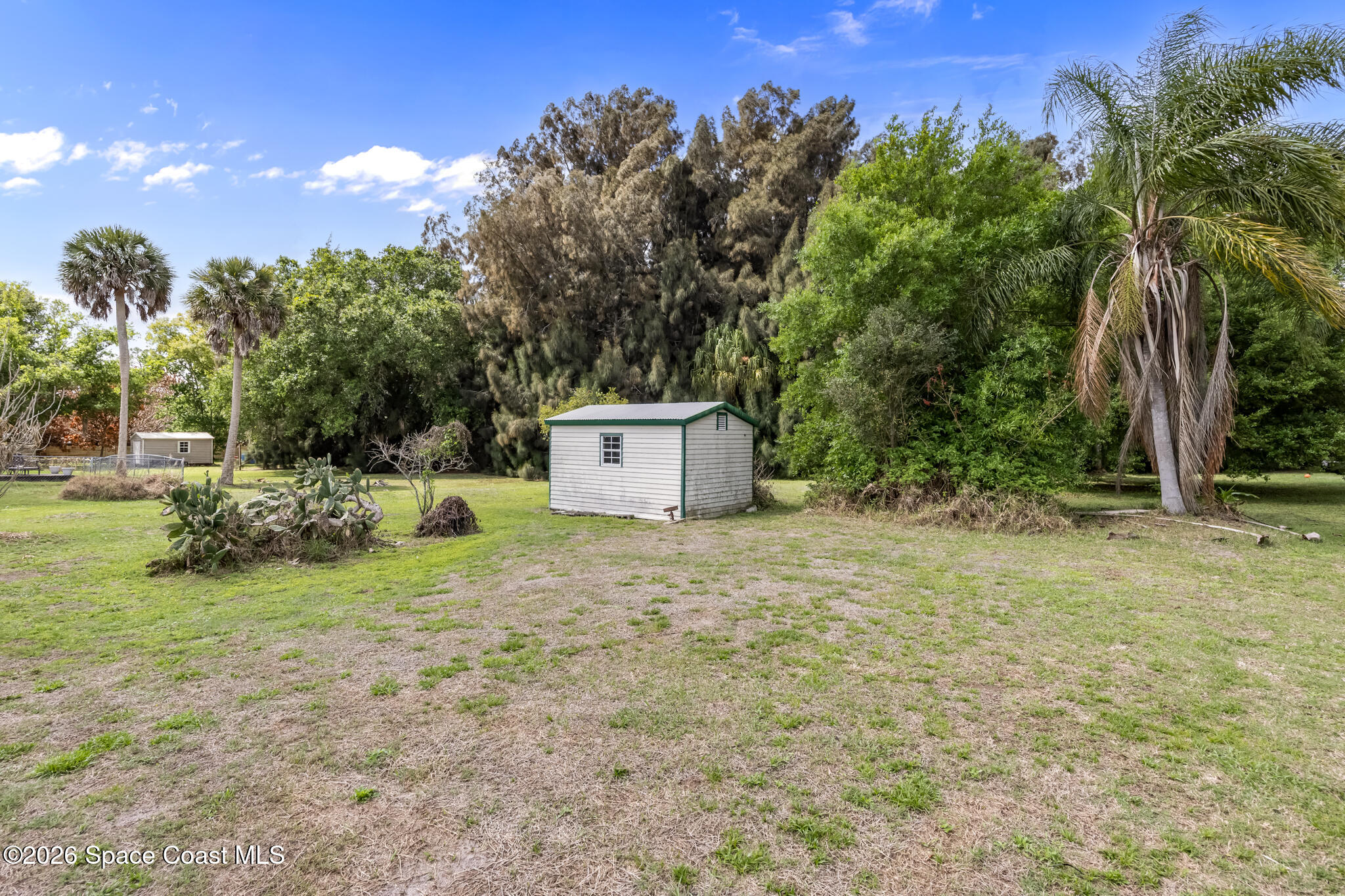 2030 City Acres Road Melbourne, FL 32904 - Photo 27 of 31 a backyard of a house with plants and large trees