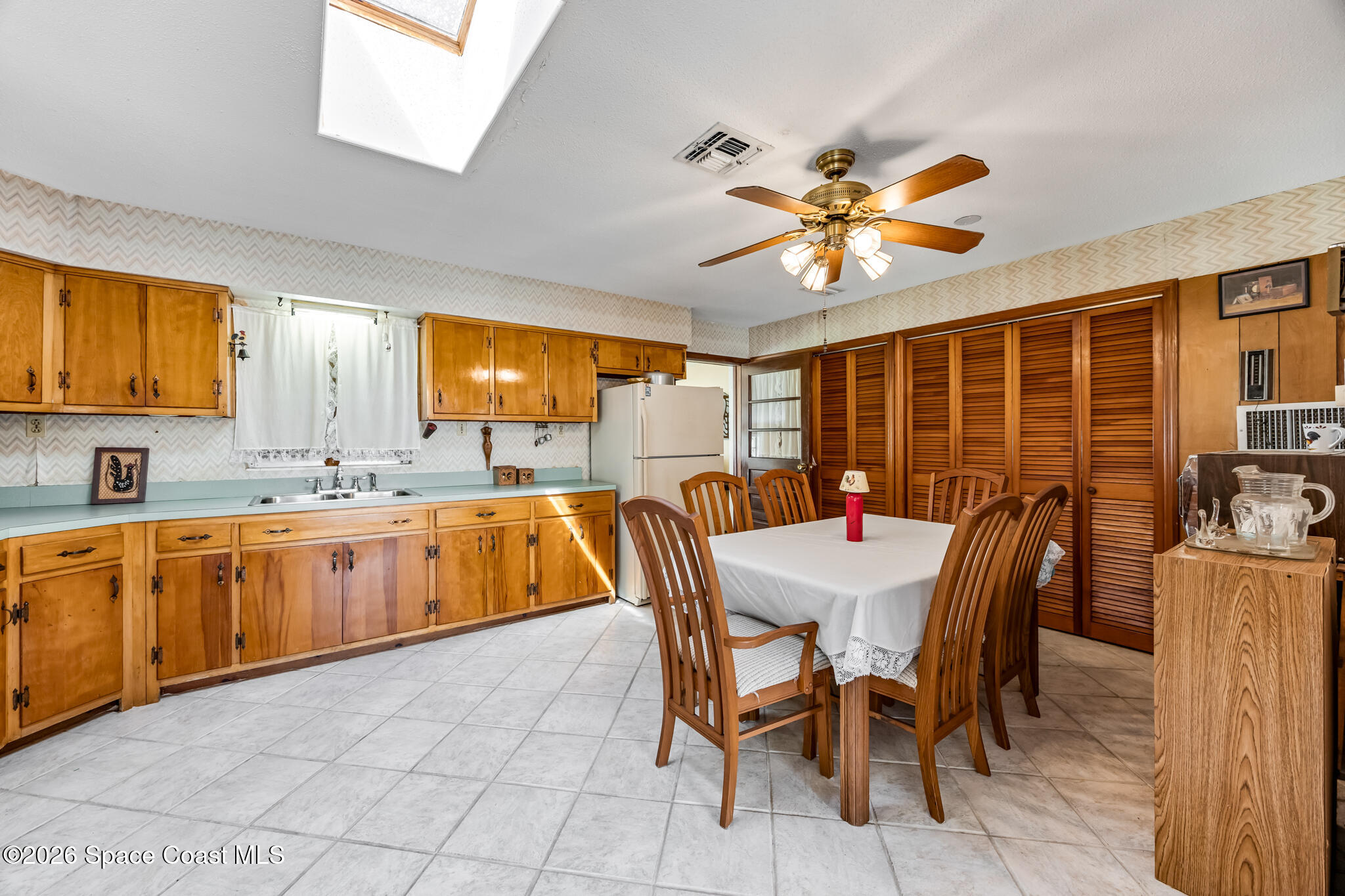 2030 City Acres Road Melbourne, FL 32904 - Photo 6 of 31 a dining area with stainless steel appliances a table chairs and a sink