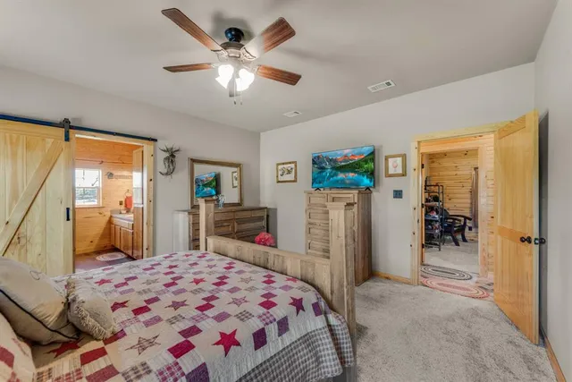 a bedroom with a bed dresser and a large mirror