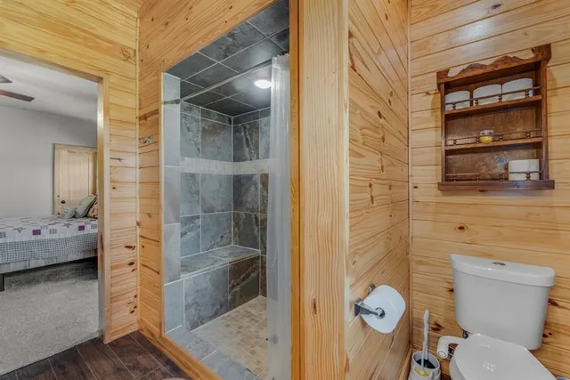 a bathroom with a toilet and a shower