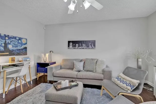 a living room with furniture and a kitchen