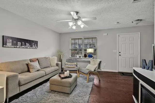 a living room with furniture and a chandelier