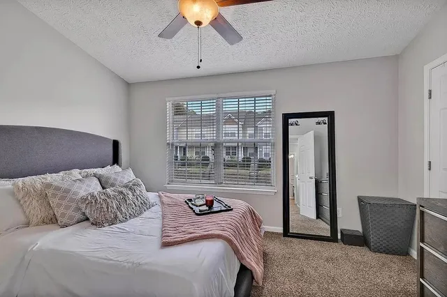 a bedroom with a bed and a chandelier