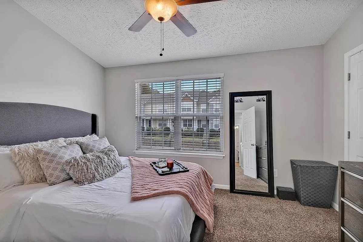 1504 Sprucedale Drive Antioch, TN 37013 - Photo 17 of 30 a bedroom with a bed and a chandelier