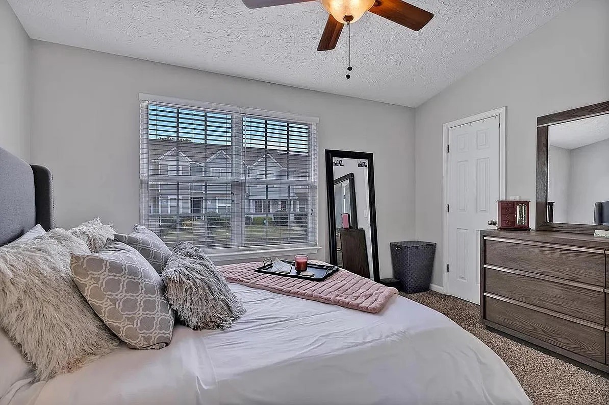 1504 Sprucedale Drive Antioch, TN 37013 - Photo 20 of 30 a bedroom with a large bed and a chandelier