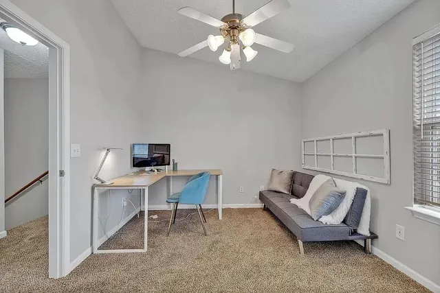 a workspace with furniture and a window