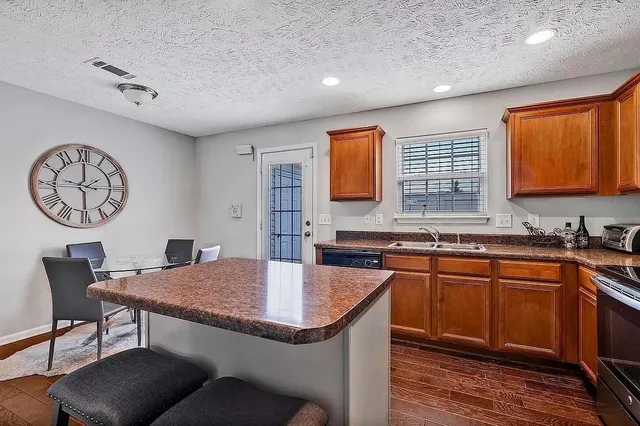 a kitchen with a table chairs sink and cabinets