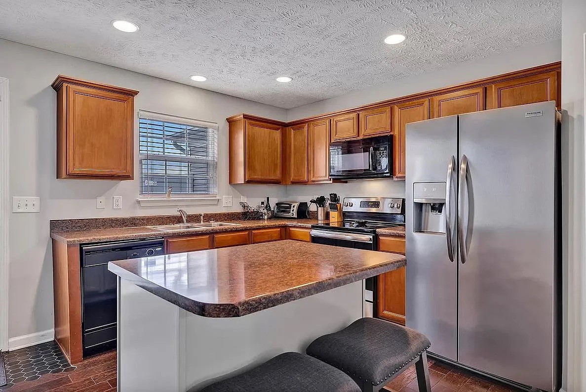 1504 Sprucedale Drive Antioch, TN 37013 - Photo 9 of 30 a kitchen with stainless steel appliances granite countertop a refrigerator a sink dishwasher a stove with wooden cabinets and a refrigerator