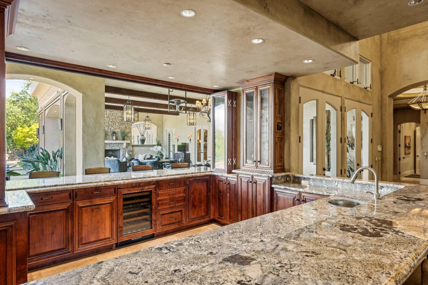 5687 Ridge Park Drive Loomis, CA 95650 - Photo 17 of 79 a large kitchen with kitchen island granite countertop a large window and a sink