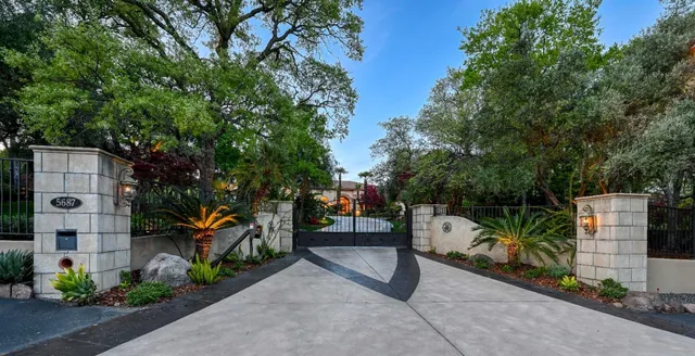 an aerial view of a house with a yard and lake view