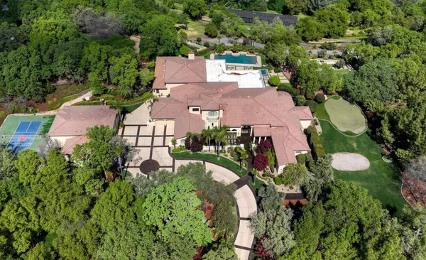 a front view of a house with a yard and a garage