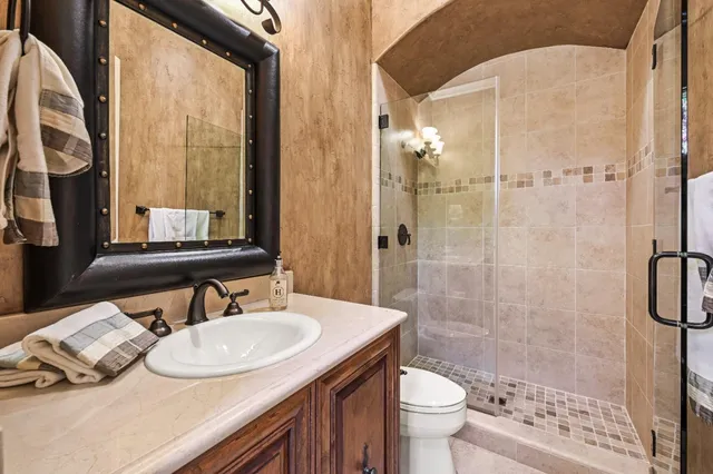 a bathroom with a toilet a sink and a mirror