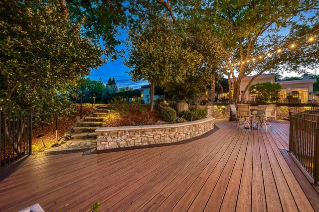 a front view of a house with a yard and fountain in middle