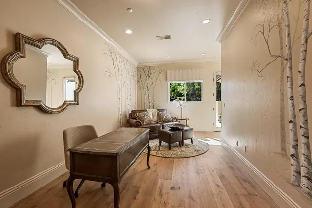 a living room with furniture a chandelier and a fireplace