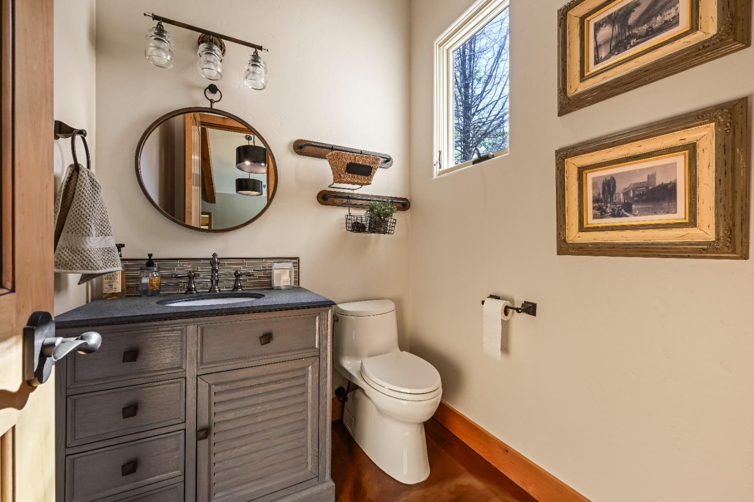 5687 Ridge Park Drive Loomis, CA 95650 - Photo 49 of 79 a bathroom with a toilet a sink and a mirror