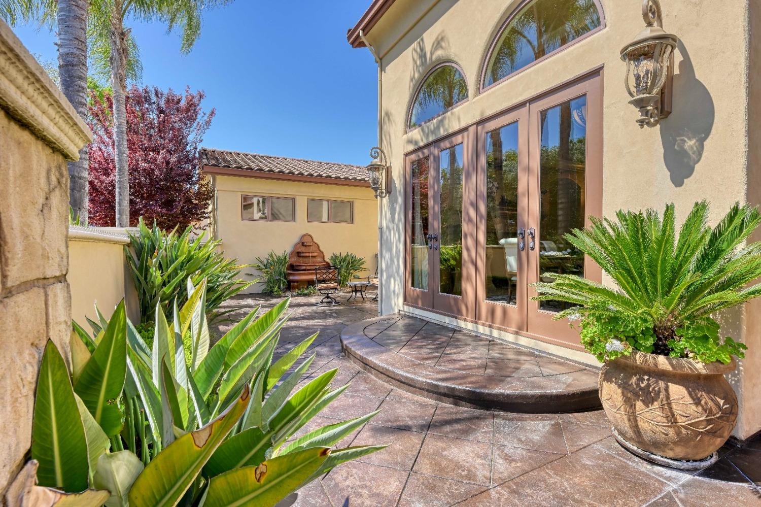 5687 Ridge Park Drive Loomis, CA 95650 - Photo 5 of 79 a potted plant sitting in front of a house