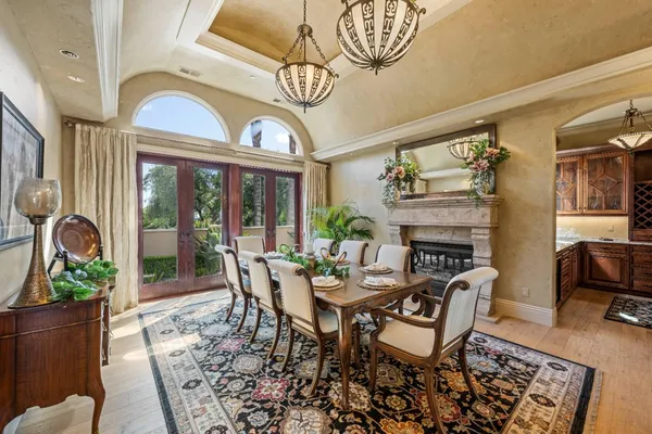 a living room with furniture a chandelier and a rug