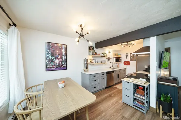 a view of a dining room with furniture a rug and wooden floor